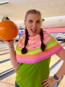 Kelly wearing Good Day while holding up a bowling ball